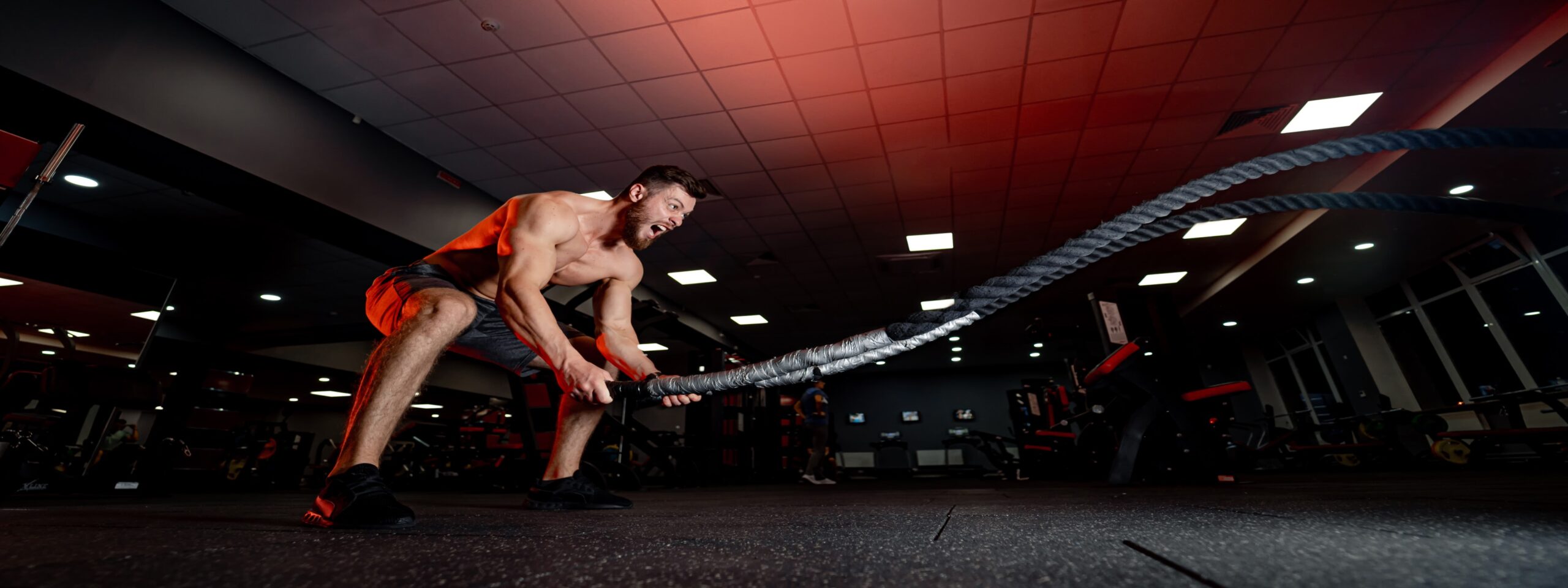 athletic-man-doing-some-cross-training-exercises-with-ropes-gym-heavy-training